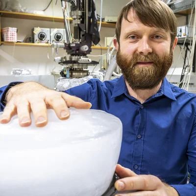 Bearded man with ice block in the laboratory